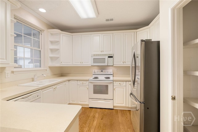 205 Meadowlark Cir, Savannah, GA 31419 - kitchen with white appliances, a sink, light wood-type flooring, white cabinets, and light countertops