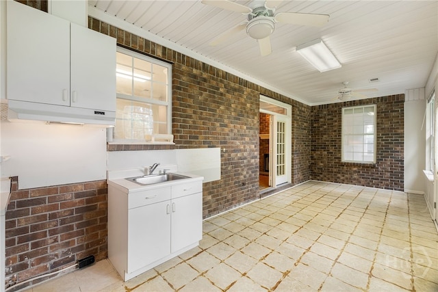 205 Meadowlark Cir, Savannah, GA 31419 - kitchen featuring brick wall, a sink, ceiling fan, plenty of natural light, and light countertops