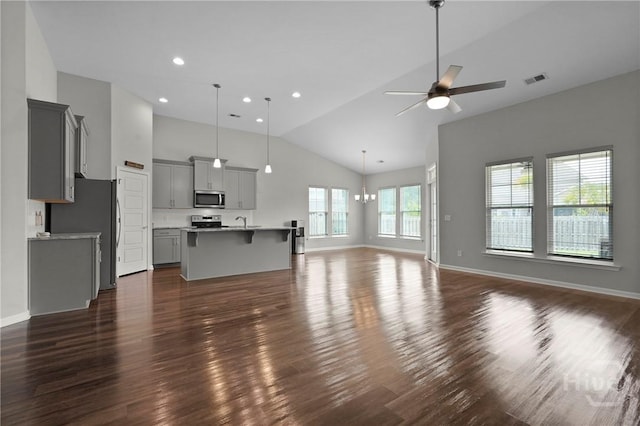 2 Chimney Ct, Savannah, GA 31407 - unfurnished living room featuring dark wood-style flooring, ceiling fan, high vaulted ceiling, baseboards, and a sink