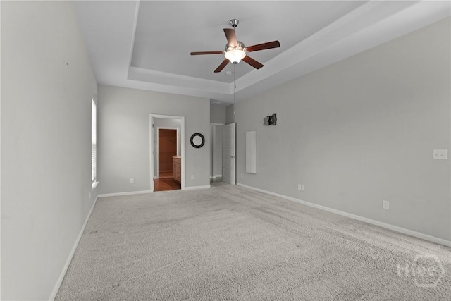 2 Chimney Ct, Savannah, GA 31407 - unfurnished bedroom with a tray ceiling, carpet floors, baseboards, ensuite bath, and ceiling fan