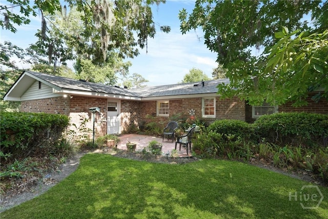 604 Windsor Rd, Savannah, GA 31419 - back of property with brick siding, a lawn, and a patio