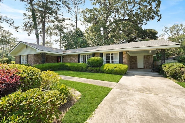 604 Windsor Rd, Savannah, GA 31419 - single story home with brick siding, driveway, a front yard, and a carport