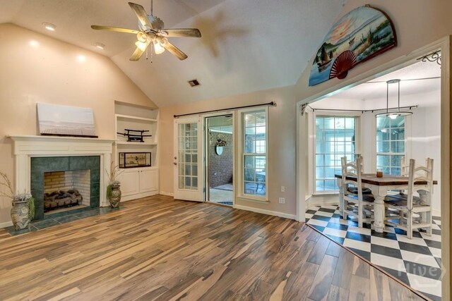 510 Mallory Rd, Reidsville, GA 30453 - unfurnished living room featuring lofted ceiling, ceiling fan, wood finished floors, baseboards, and a tile fireplace