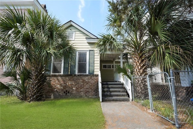 514 W 38th St, Savannah, GA 31415 - view of front of home featuring brick siding and a gate