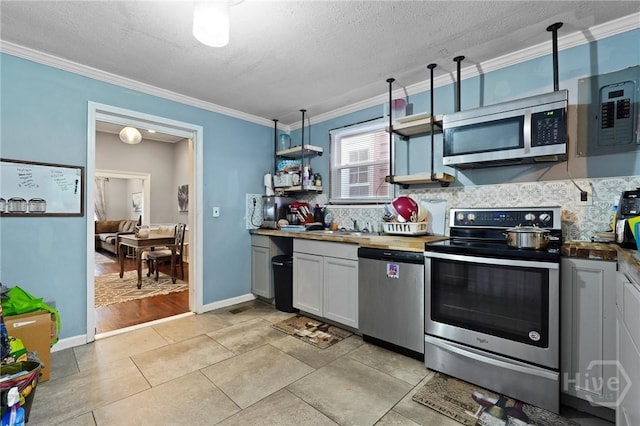 514 W 38th St, Savannah, GA 31415 - kitchen with appliances with stainless steel finishes, open shelves, backsplash, crown molding, and a textured ceiling