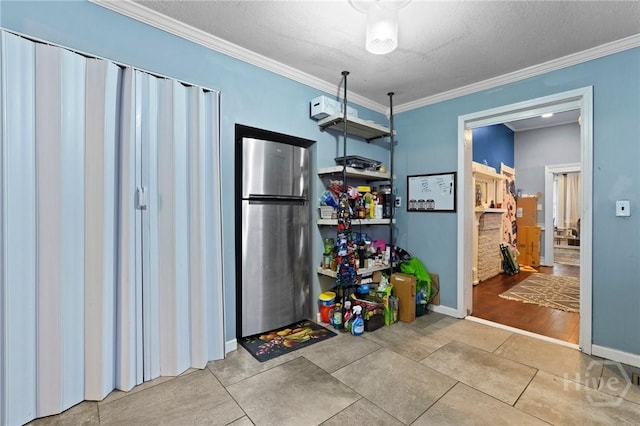 514 W 38th St, Savannah, GA 31415 - kitchen with freestanding refrigerator, crown molding, baseboards, and a textured ceiling