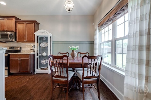 109 Oaklawn Dr, Rincon, GA 31326 - dining area featuring dark wood-style flooring, healthy amount of natural light, and a wainscoted wall