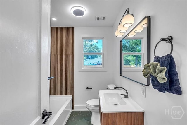 2501 Louisiana Ave, Savannah, GA 31404 - bathroom featuring tile patterned flooring, toilet, a tub, baseboards, and vanity