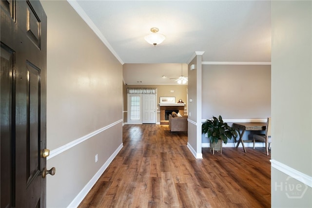 209 Saint James Walk, Guyton, GA 31312 - foyer entrance with a ceiling fan, crown molding, dark wood-type flooring, baseboards, and a brick fireplace
