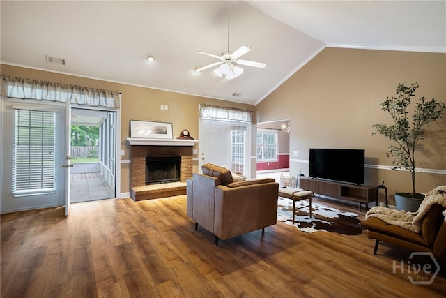 209 Saint James Walk, Guyton, GA 31312 - living room with lofted ceiling, a fireplace, ornamental molding, a ceiling fan, and baseboards