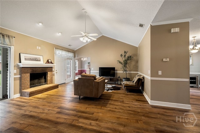 209 Saint James Walk, Guyton, GA 31312 - living room featuring a fireplace, dark wood-style floors, ceiling fan, vaulted ceiling, and ornamental molding