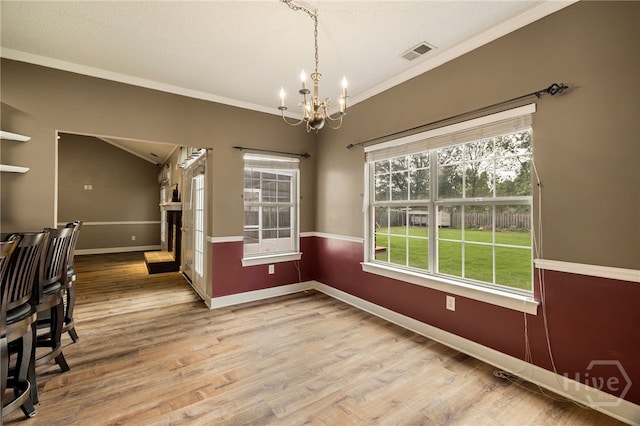 209 Saint James Walk, Guyton, GA 31312 - unfurnished dining area with a chandelier, baseboards, wood finished floors, ornamental molding, and vaulted ceiling
