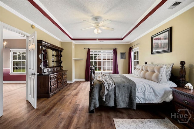 209 Saint James Walk, Guyton, GA 31312 - bedroom with a tray ceiling, wood finished floors, ornamental molding, baseboards, and a textured ceiling