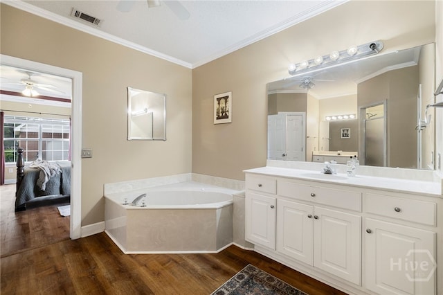 209 Saint James Walk, Guyton, GA 31312 - full bath featuring a ceiling fan, wood finished floors, a bath, vanity, and crown molding