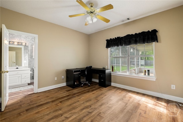 209 Saint James Walk, Guyton, GA 31312 - unfurnished office with wood finished floors, baseboards, a sink, and a ceiling fan