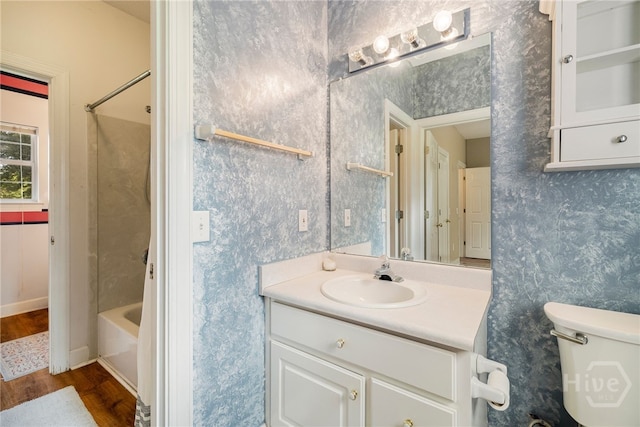 209 Saint James Walk, Guyton, GA 31312 - bathroom featuring wood finished floors, vanity, toilet, shower / tub combination, and wallpapered walls