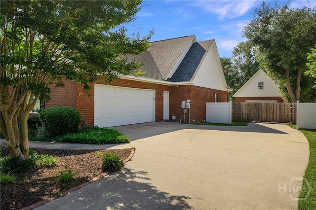 209 Saint James Walk, Guyton, GA 31312 - view of side of property featuring driveway, a garage, brick siding, and roof with shingles