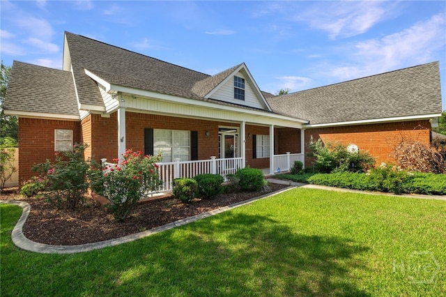 209 Saint James Walk, Guyton, GA 31312 - view of front of house featuring brick siding, covered porch, a front lawn, and roof with shingles