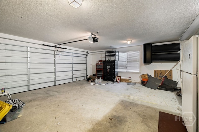 209 Saint James Walk, Guyton, GA 31312 - garage with freestanding refrigerator and a garage door opener
