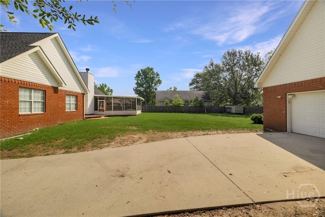 209 Saint James Walk, Guyton, GA 31312 - view of yard with a sunroom, a garage, and concrete driveway