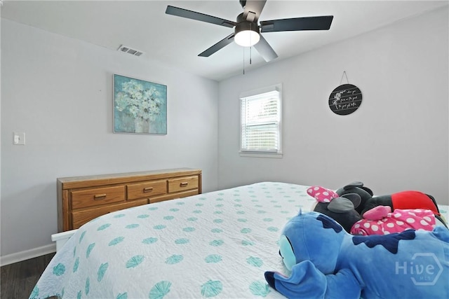 1504 Audubon Dr, Savannah, GA 31415 - bedroom with dark wood finished floors, baseboards, and a ceiling fan