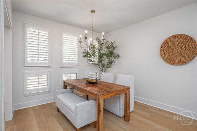 66 Dame Kathryn Dr, Savannah, GA 31411 - dining room with a chandelier, light wood-style flooring, and baseboards