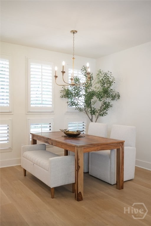 66 Dame Kathryn Dr, Savannah, GA 31411 - dining space with light wood-style floors, a chandelier, baseboards, and plenty of natural light
