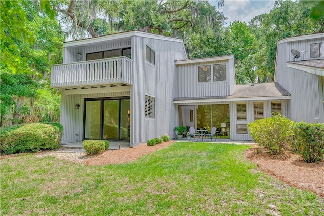 66 Dame Kathryn Dr, Savannah, GA 31411 - rear view of property with a lawn, a balcony, a patio, and view of wooded area
