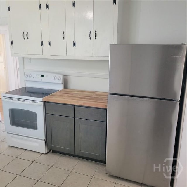 1214 Delesseps Ave, Savannah, GA 31404 - kitchen featuring freestanding refrigerator, white range with electric cooktop, wood counters, and light tile patterned floors