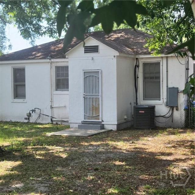 1214 Delesseps Ave, Savannah, GA 31404 - view of front of house featuring a shingled roof, central air condition unit, entry steps, and stucco siding