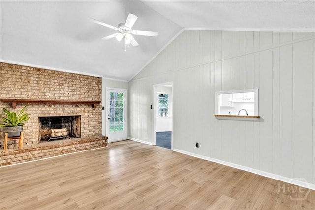 28 Red Fox Dr, Savannah, GA 31419 - unfurnished living room with wood finished floors, vaulted ceiling, a fireplace, a ceiling fan, and baseboards