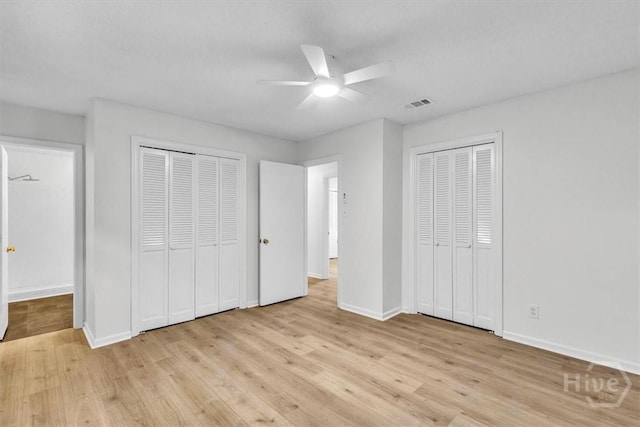 28 Red Fox Dr, Savannah, GA 31419 - unfurnished bedroom with two closets, light wood finished floors, baseboards, and a ceiling fan