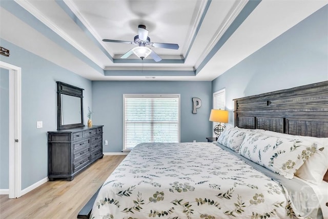 150 Laurenburg Dr, Richmond Hill, GA 31324 - bedroom featuring a tray ceiling, light wood-style flooring, baseboards, and a ceiling fan