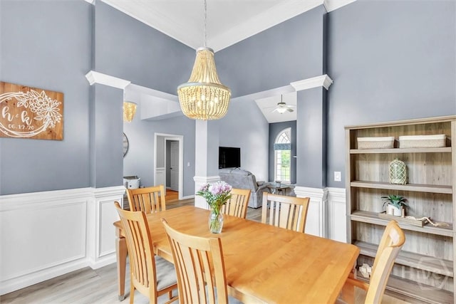 150 Laurenburg Dr, Richmond Hill, GA 31324 - dining area with high vaulted ceiling, ceiling fan, a chandelier, and light wood-style flooring