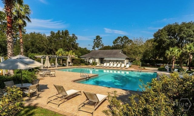 150 Laurenburg Dr, Richmond Hill, GA 31324 - community pool with a pergola, a patio area, and view of scattered trees