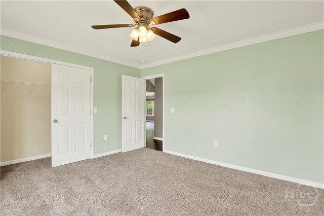 29 Joy Ln, Midway, GA 31320 - unfurnished bedroom with ornamental molding, carpet flooring, baseboards, a closet, and a ceiling fan