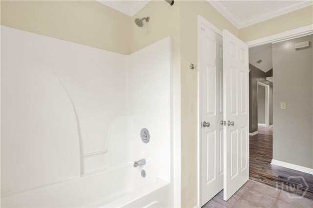 29 Joy Ln, Midway, GA 31320 - full bathroom featuring shower / bath combination, tile patterned floors, ornamental molding, and baseboards