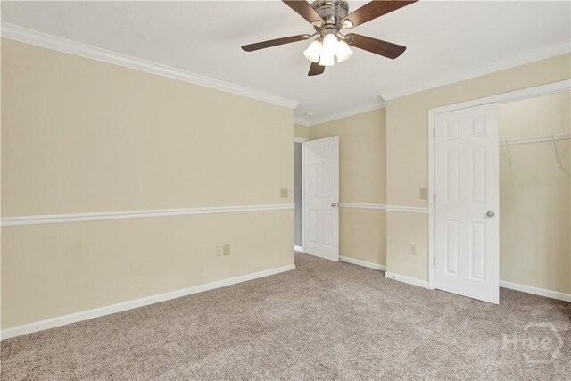 29 Joy Ln, Midway, GA 31320 - unfurnished bedroom with carpet, crown molding, a closet, baseboards, and a ceiling fan