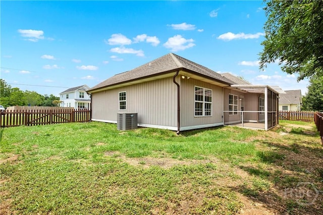 29 Joy Ln, Midway, GA 31320 - rear view of house featuring cooling unit, a sunroom, and a shingled roof