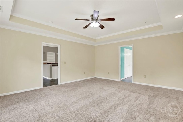 29 Joy Ln, Midway, GA 31320 - spare room featuring a tray ceiling, carpet flooring, crown molding, ceiling fan, and baseboards