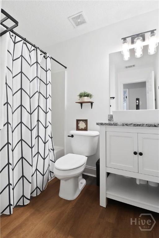 310 Tibet Ave Unit 10, Savannah, GA 31406 - full bathroom with wood finished floors, toilet, vanity, and shower / bath combination with curtain