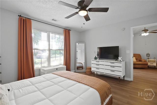 310 Tibet Ave Unit 10, Savannah, GA 31406 - bedroom featuring wood finished floors, a textured ceiling, ceiling fan, and baseboards