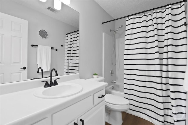 310 Tibet Ave Unit 10, Savannah, GA 31406 - bathroom featuring a textured ceiling, vanity, toilet, shower / bath combination with curtain, and wood finished floors