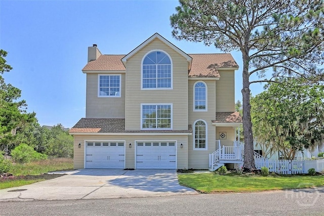 98 Picket Row, Savannah, GA 31410 - traditional-style home featuring concrete driveway, an attached garage, a chimney, and a shingled roof