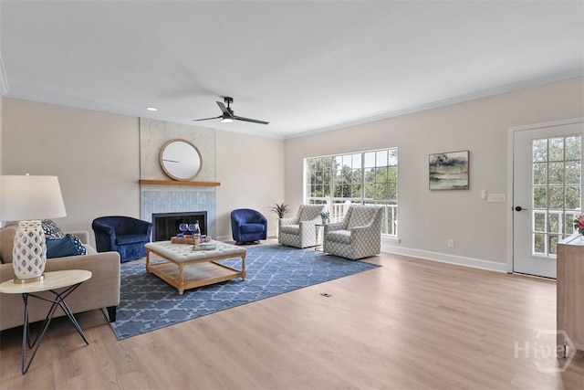 98 Picket Row, Savannah, GA 31410 - living area with wood finished floors, healthy amount of natural light, a ceiling fan, a tile fireplace, and crown molding