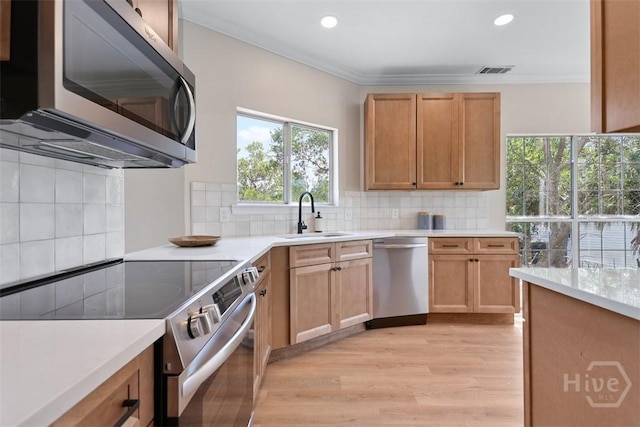 98 Picket Row, Savannah, GA 31410 - kitchen with appliances with stainless steel finishes, a sink, light wood-style floors, light countertops, and decorative backsplash