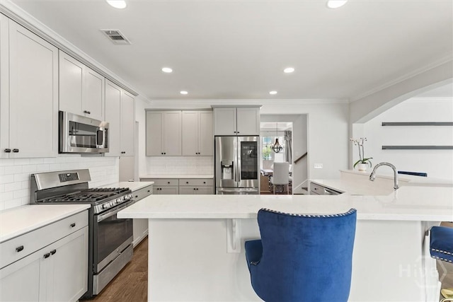 301 Highland Cir, Richmond Hill, GA 31324 - kitchen with stainless steel appliances, ornamental molding, a breakfast bar, recessed lighting, and dark wood-style flooring