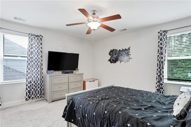 301 Highland Cir, Richmond Hill, GA 31324 - bedroom featuring multiple windows, light carpet, and ceiling fan