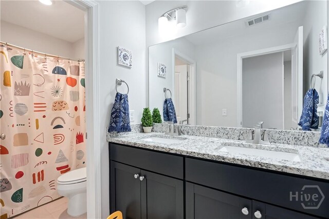 301 Highland Cir, Richmond Hill, GA 31324 - full bath featuring toilet, double vanity, tile patterned floors, and a shower with curtain