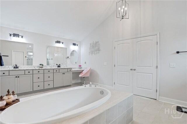 301 Highland Cir, Richmond Hill, GA 31324 - bathroom with lofted ceiling, a garden tub, double vanity, and tile patterned flooring